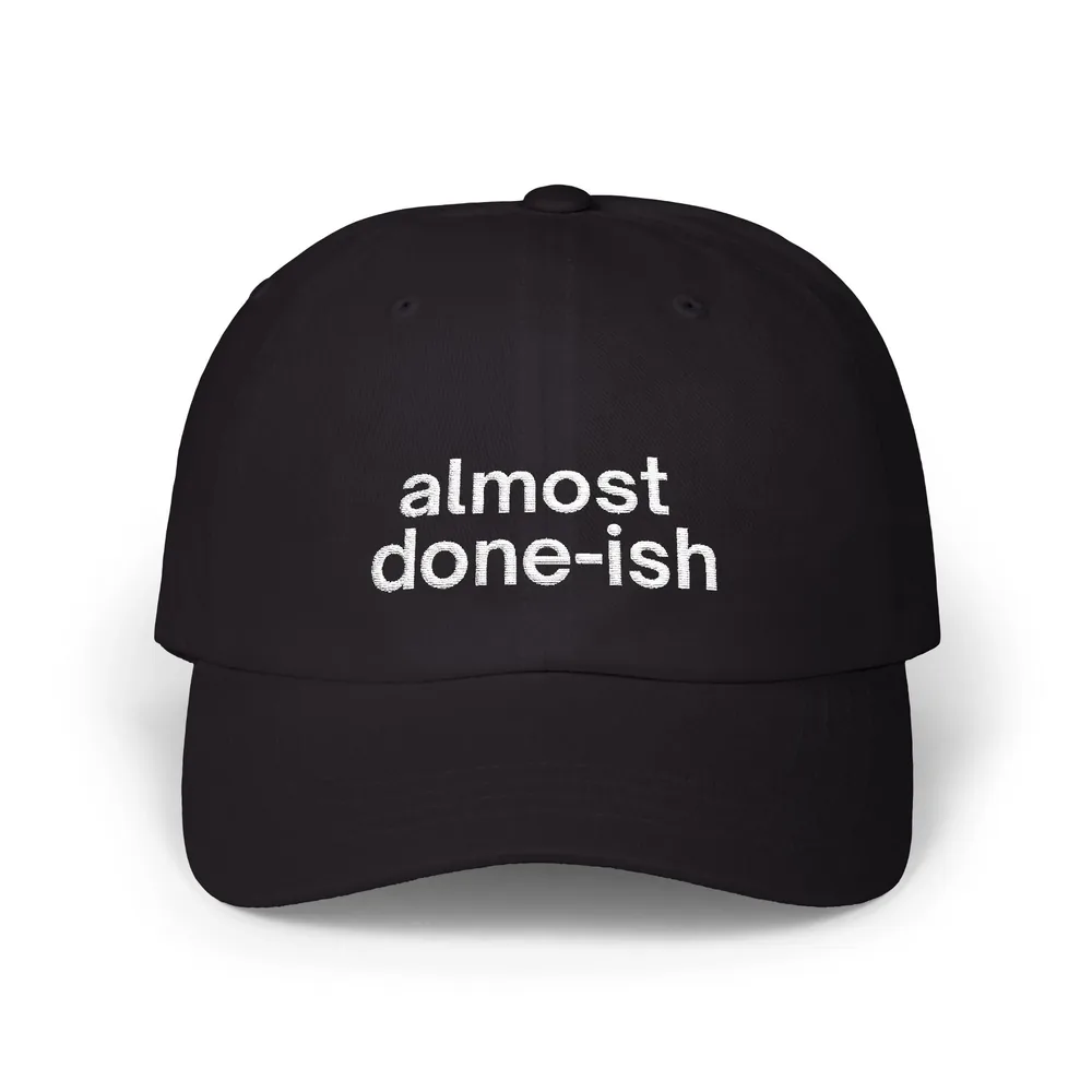 Black dad cap reading almost done-ish.